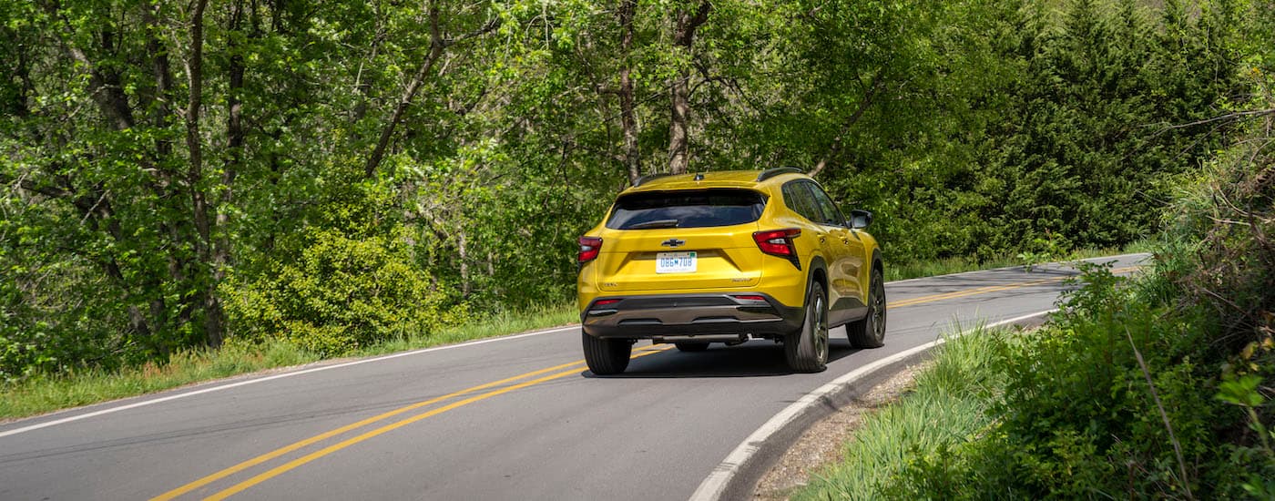 A yellow 2024 Chevy Trax Activ is shown from the rear at an angle.