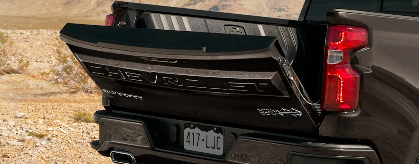 A close up of the tailgate on a black 2022 Chevy Silverado 1500 High Country is shown.