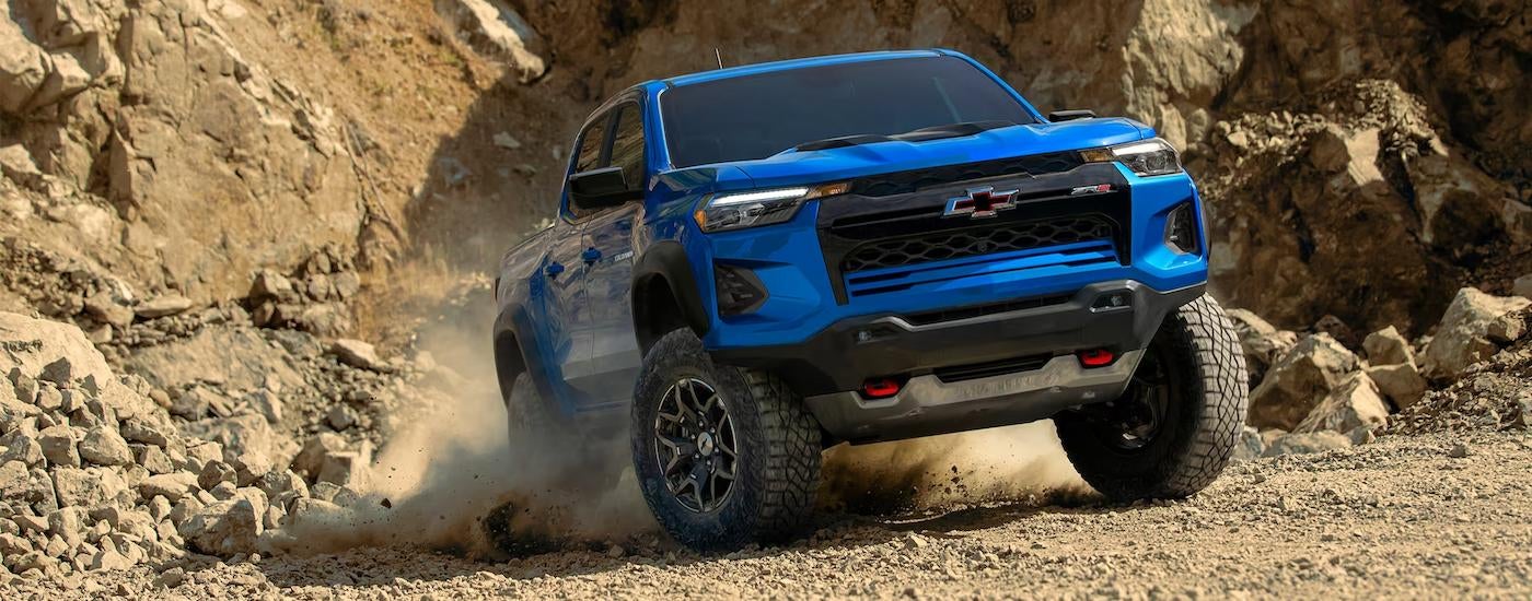 A blue 2023 Chevy Colorado ZR2 is shown off-roading after leaving a truck dealer.