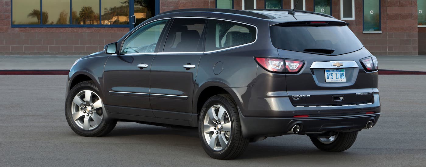 A gray 2016 Chevy Traverse is shown from a rear angle.