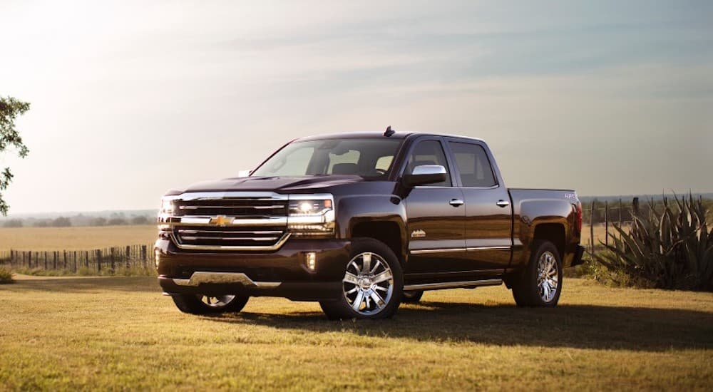 A burgundy 2017 Chevy Silverado is parked in a field.