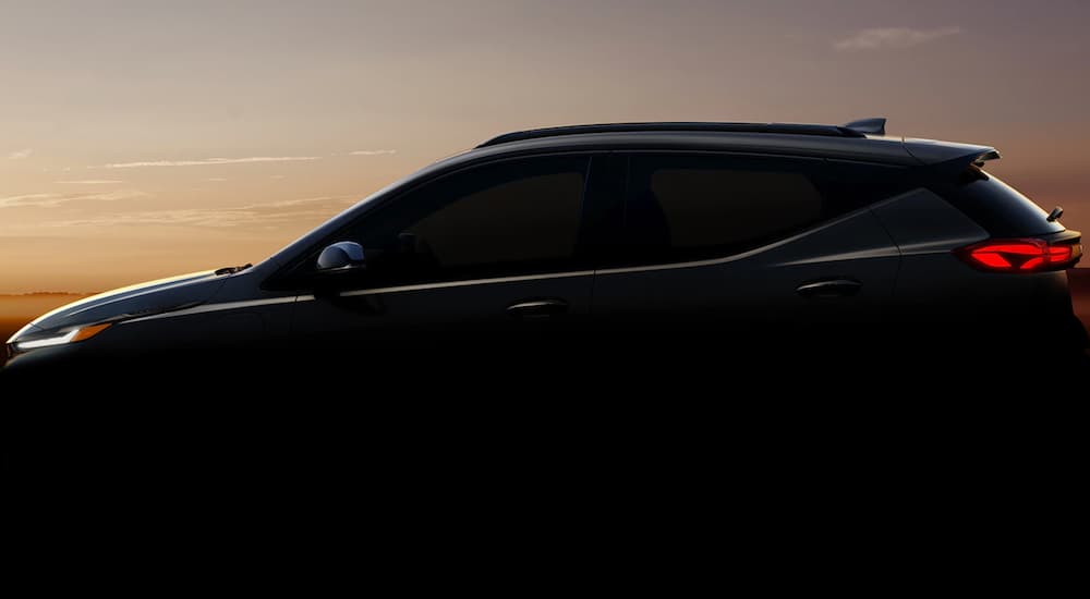 The silhouette of a 2022 Chevy Bolt EUV is shown at dusk.