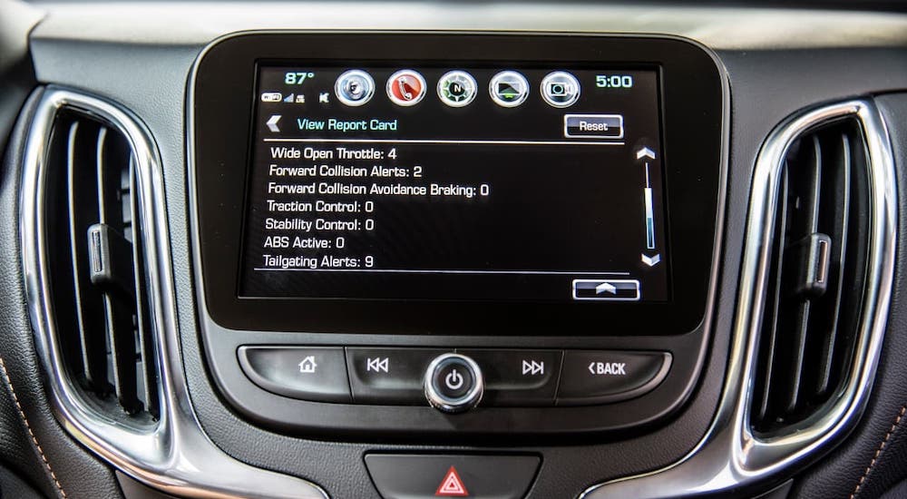 A closeup shows a report card on the infotainment screen in a 2021 Chevy Equinox.