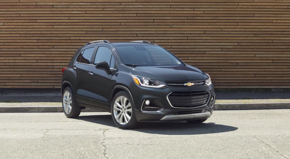 A black 2020 Chevy Trax is parked in front of a building.