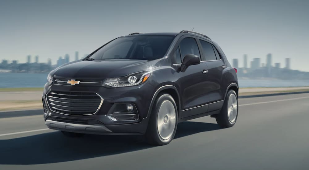 A grey 2020 Chevy Trax is driving past a city after leaving a Texas used Chevrolet dealer.