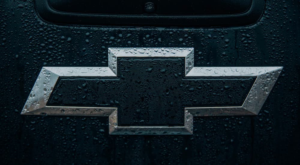 A close up shows a black and silver Chevy logo.