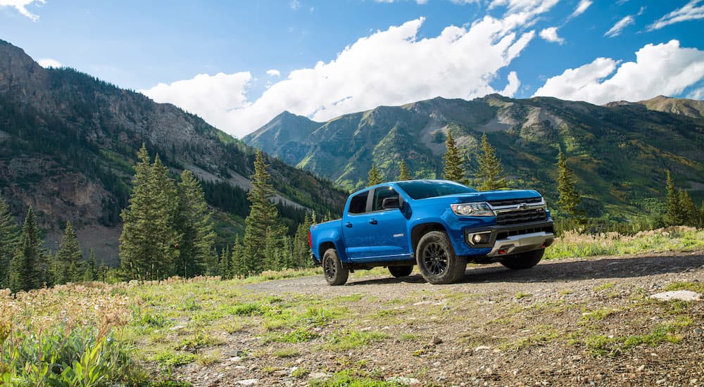 A blue 2022 Chevy Colorado is shown from the side parked in a field.