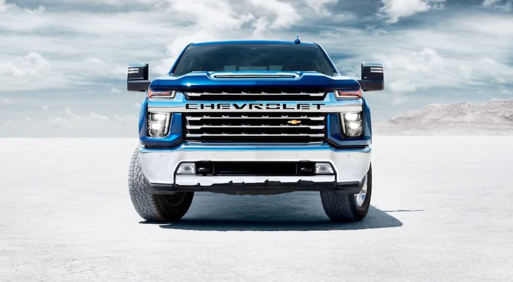 A blue 2020 Chevy Silverado 1500 is shown from the front parked on salt flats.