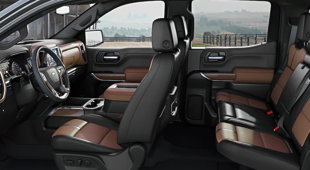 The black and brown interior of a 2022 Chevy Silverado 1500 LTD is shown at a Pinehurst Chevy dealer.