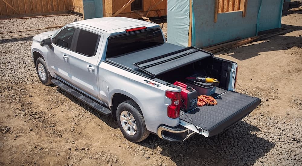 A silver 2022 Silverado 1500 LTD is shown from a rear angle at a construction site.
