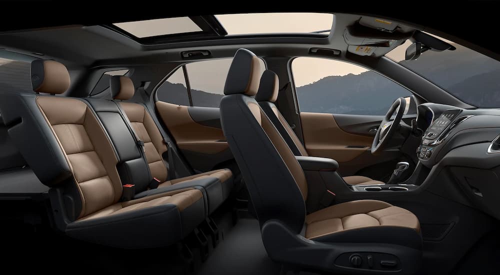 The black and brown interior of a 2023 Chevy Equinox RS is shown from the side.