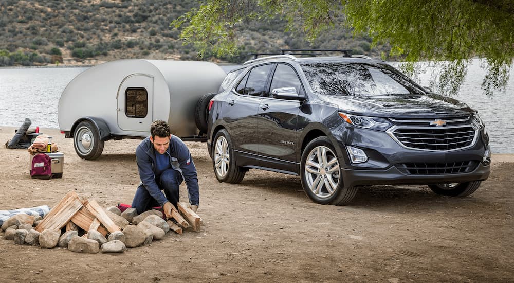 A grey 2020 Chevy Equinox is shown at a campsite.