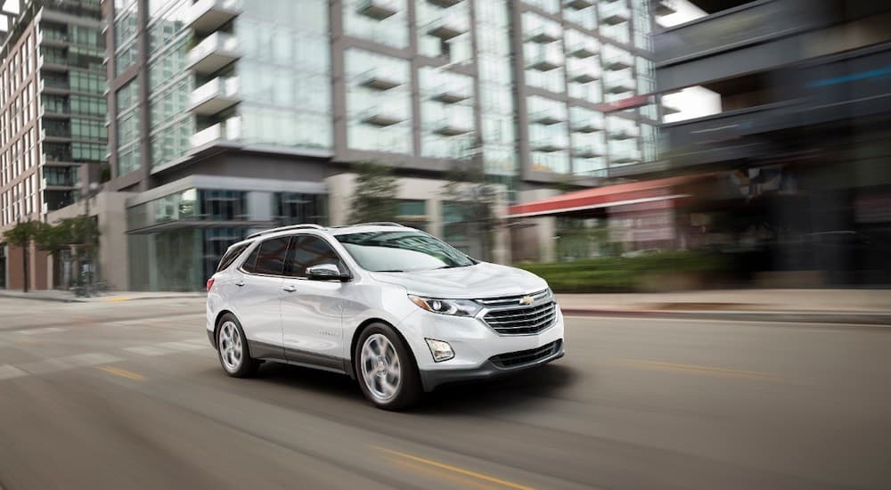 A white 2018 Chevy Equinox is shown from the front at an angle.
