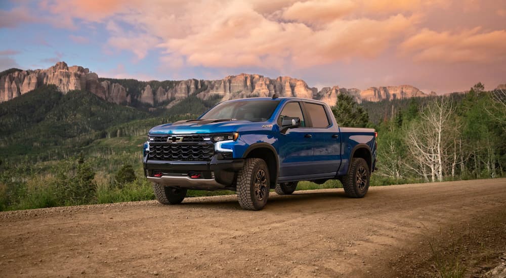 A blue 2023 Chevy Silverado 1500 ZR2 is shown on a trail after leaving a Chevy Silverado dealer near The Woodlands, TX.