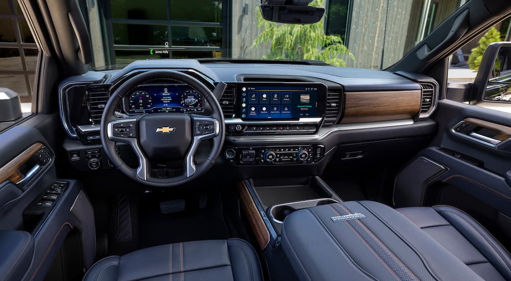 The black and brown interior of 2024 Chevy Silverado 2500 HD High Country is shown from the from seats.