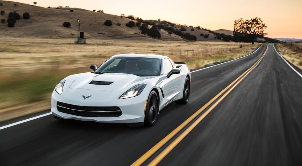 A white 2019 Chevy Corvette Stingray is shown from the front at an angle.