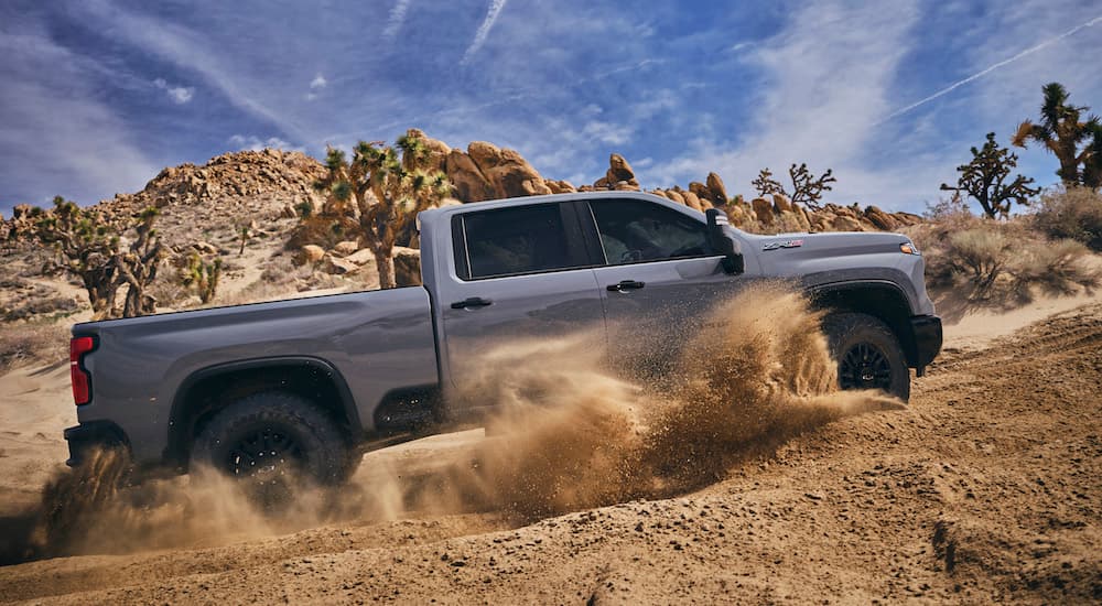 A grey 2024 Chevy Silverado 2500 HD ZR2 is shown from the side while off-road.
