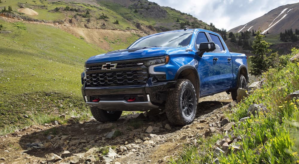 A blue 2022 Chevy Silverado 1500 ZR2 is shown from the front at an angle after leaving a dealer that has Chevy trucks for sale.
