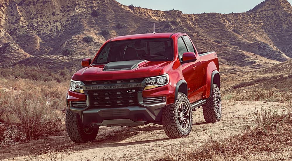 A red 2021 Chevy Colorado ZR2 is shown from the front at an angle after leaving a dealer that has used trucks for sale.
