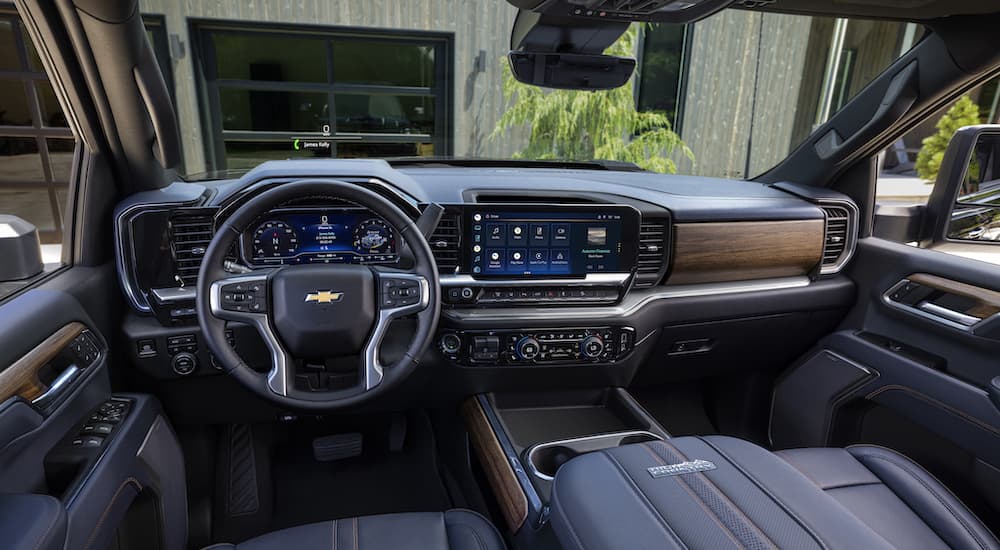 The black interior of a 2024 Chevy Silverado 2500 HD is shown from the driver's seat.