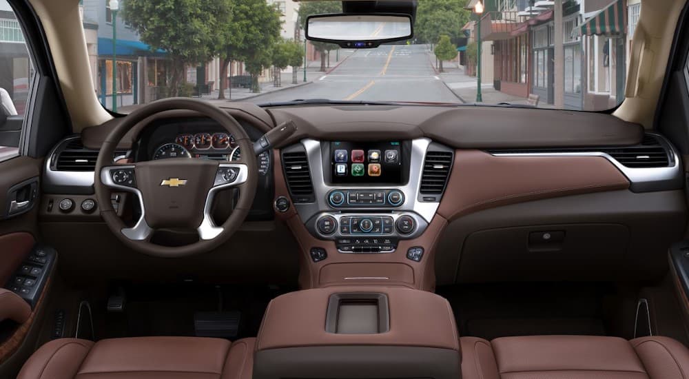 The brown interior and dash of a 2018 Chevy Tahoe is show.
