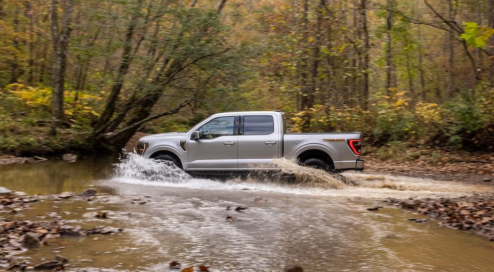 A silver 2021 Ford F-150 Tremor is shown from the side while off-road.