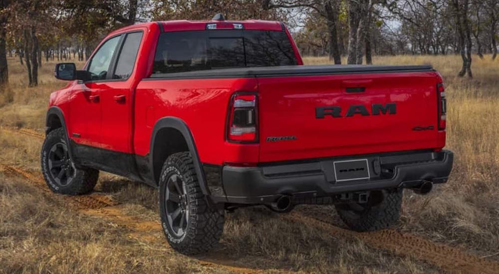 A red 2022 Ram 1500 Rebel is shown from the rear at an angle.