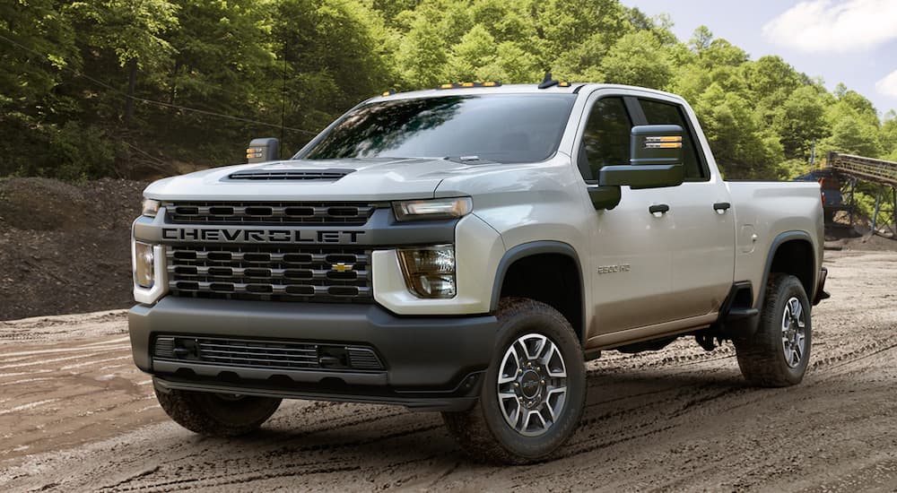 A white 2021 Chevy Silverado 2500 HD is shown from the front at an angle.