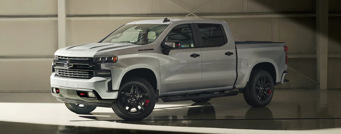 A silver 2021 Chevy Silverado 1500 is parked in a garage after leaving a Chevy Silverado dealer in Houston.