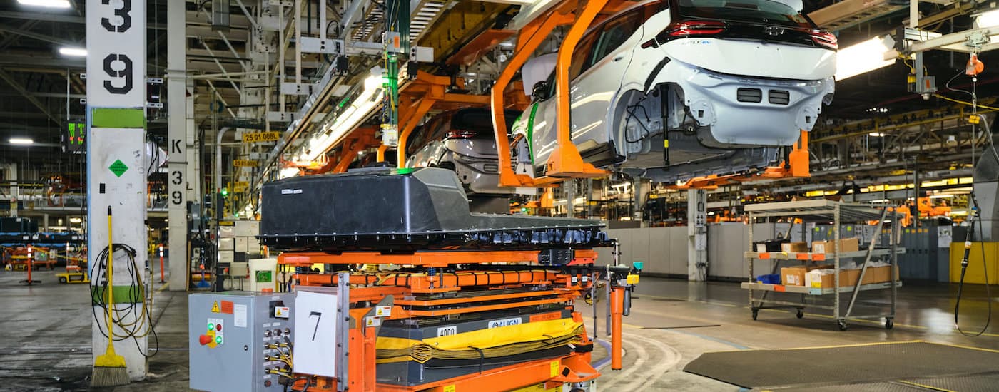 An assembly line with batteries and the 2022 Bolt EV and EUV are shown.