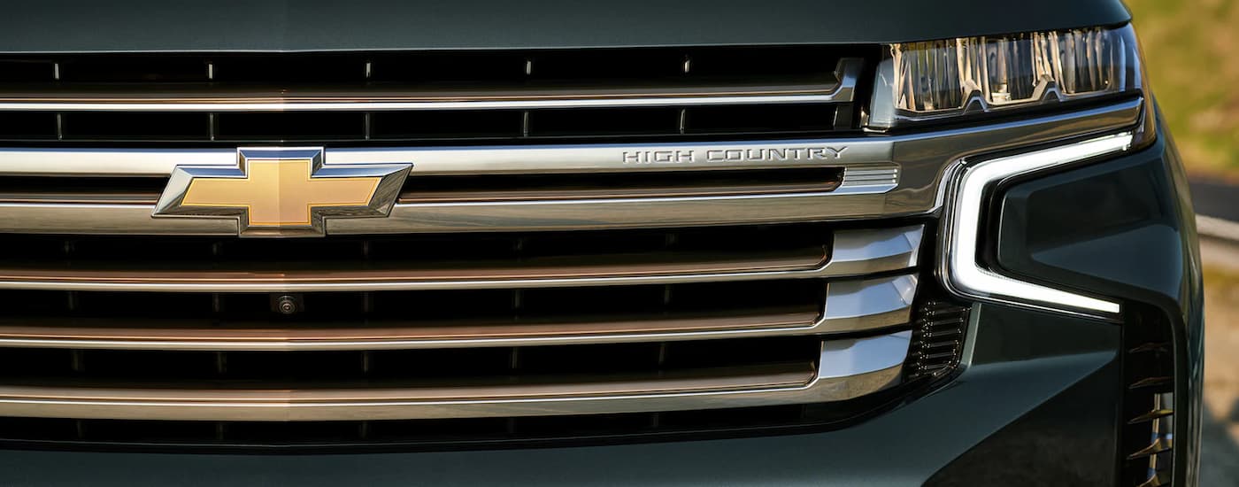 A close up of the grille of a green 2022 Chevy Tahoe High Country is shown at a Chevy Tahoe dealer near Aldine, TX.