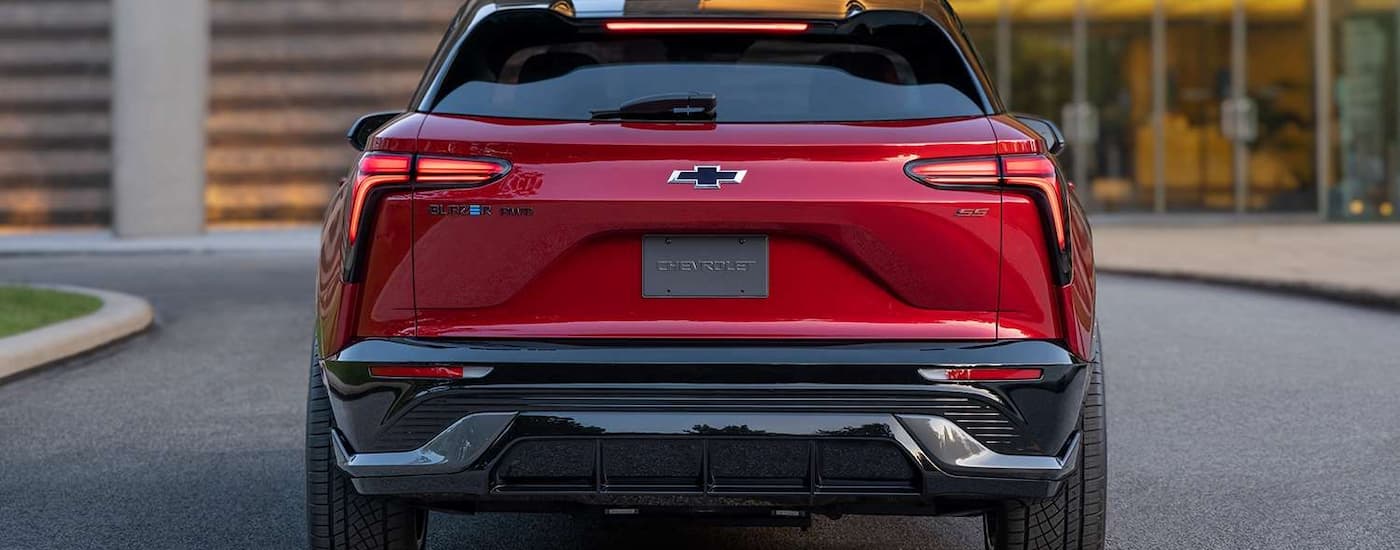 A red 2024 Chevy Blazer EV SS is shown from the rear parked in a driveway.