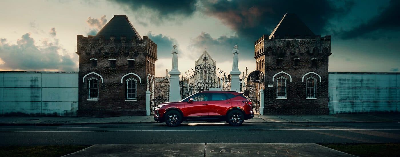 A red 2019 Chevy Blazer RS is shown from the side parked next to a cemetary.