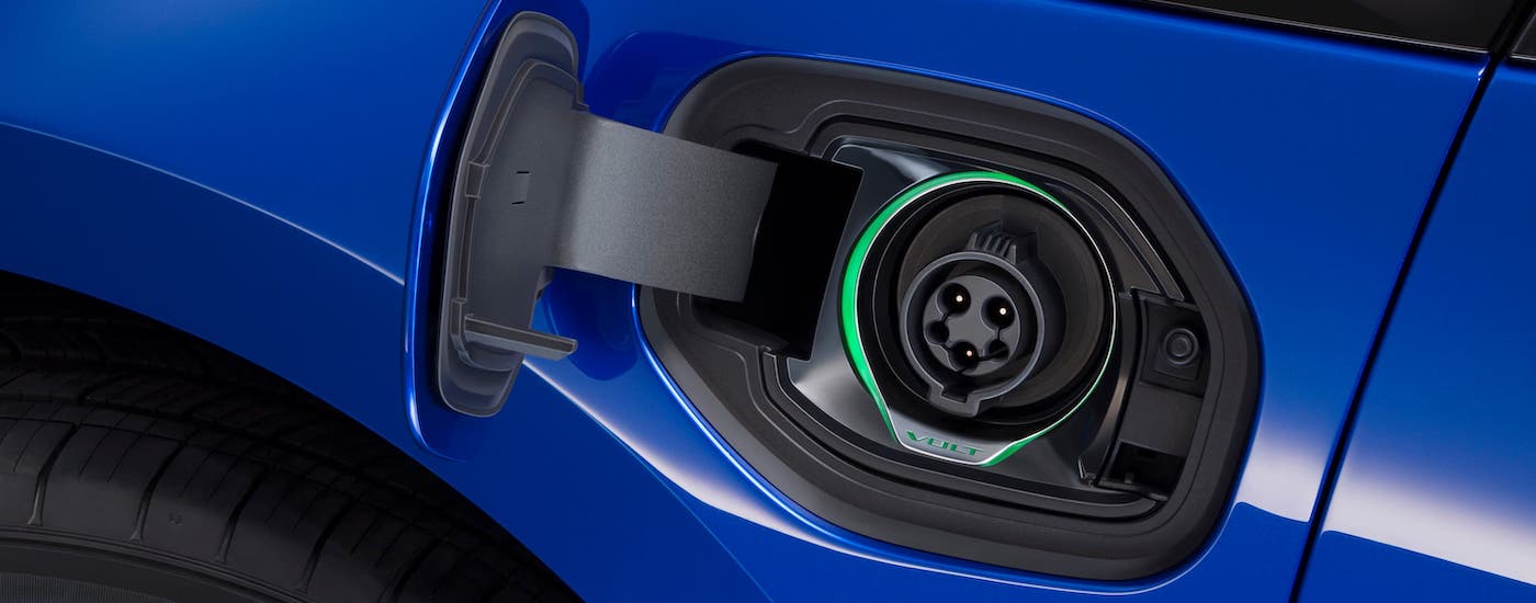 A closeup shows the charging port on a blue 2017 Chevy Volt.