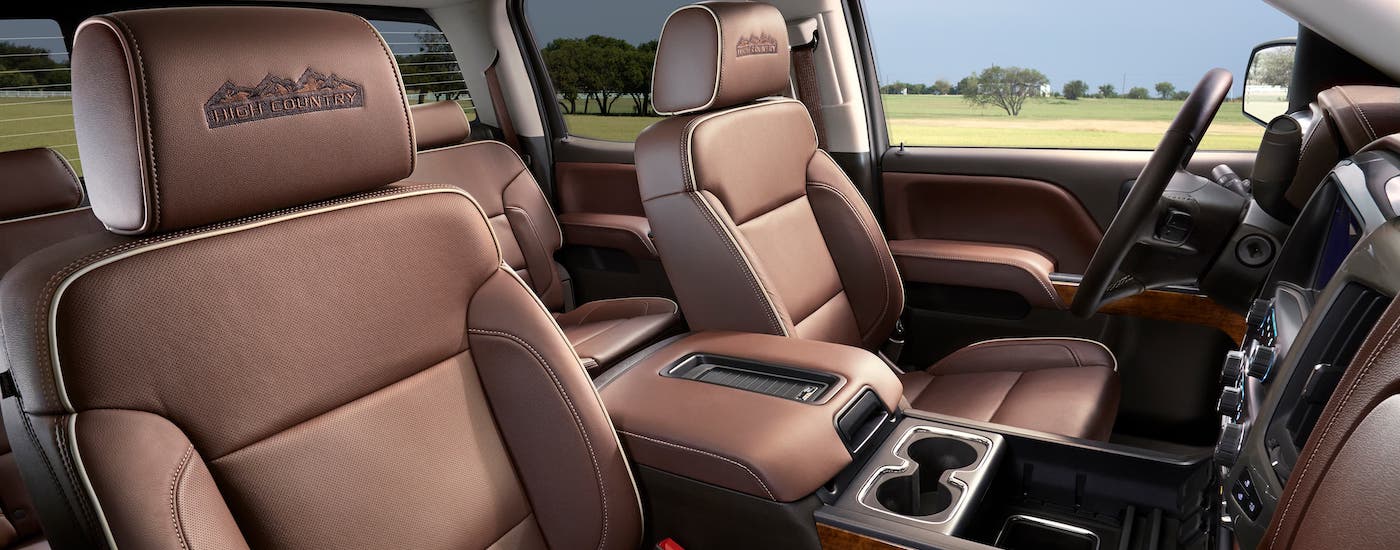 The brown leather seats are shown in a 2018 used Chevy Silverado 1500 High Country.