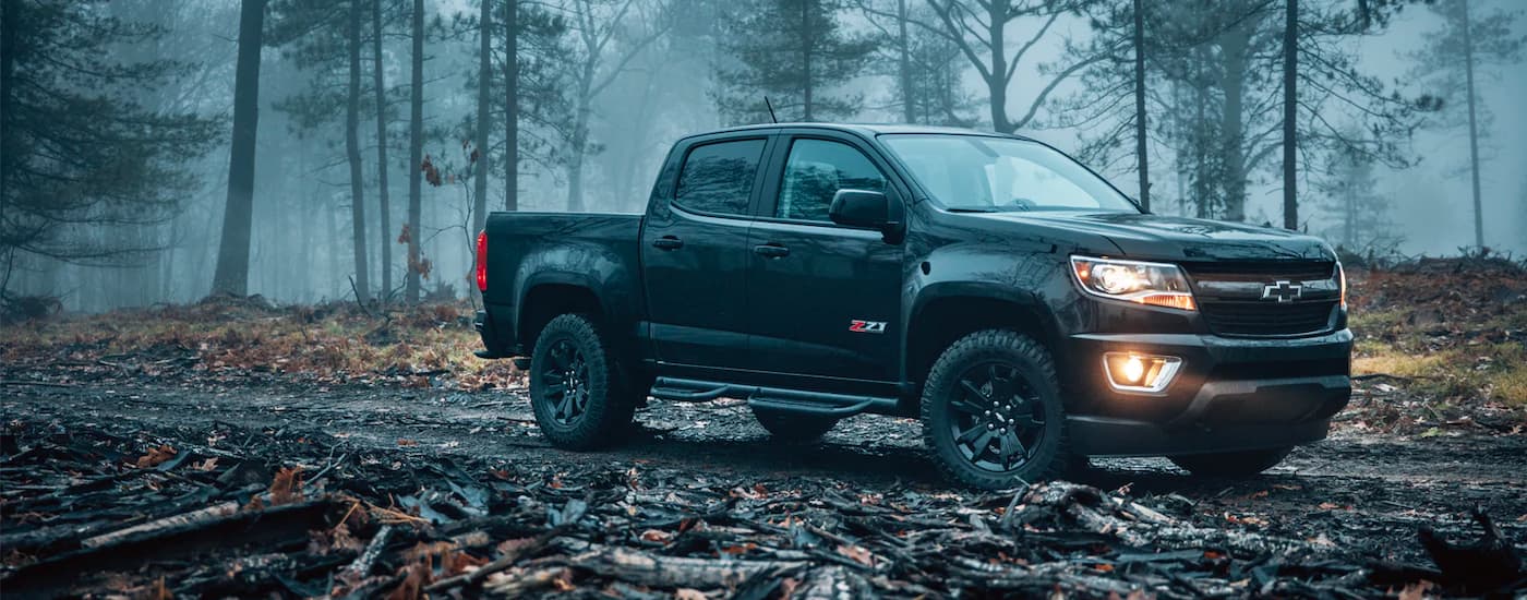 A black 2018 Chevy Colorado Z71 is shown parked in the woods.