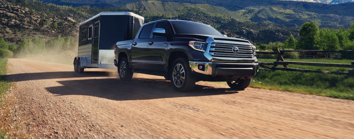 A black 2020 Toyota Tundra is shown towing a trailer.
